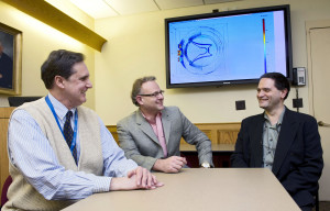 Discussing the spinal cord stimulation modeling results. From left: Kris Carlson, Ph.D., and Doctors Jeffrey Arle, and Jay Shils. All with the Neuromodulation Group at Lahey Clinic in Burlington, MA.
